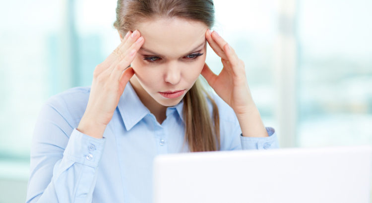 Overworking businesswoman suffering from headache
